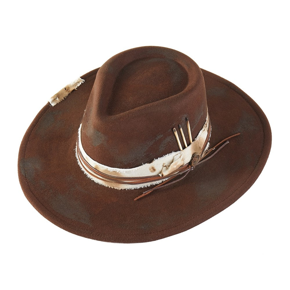 Brown cowboy hat with decorative band and feathers on a white background