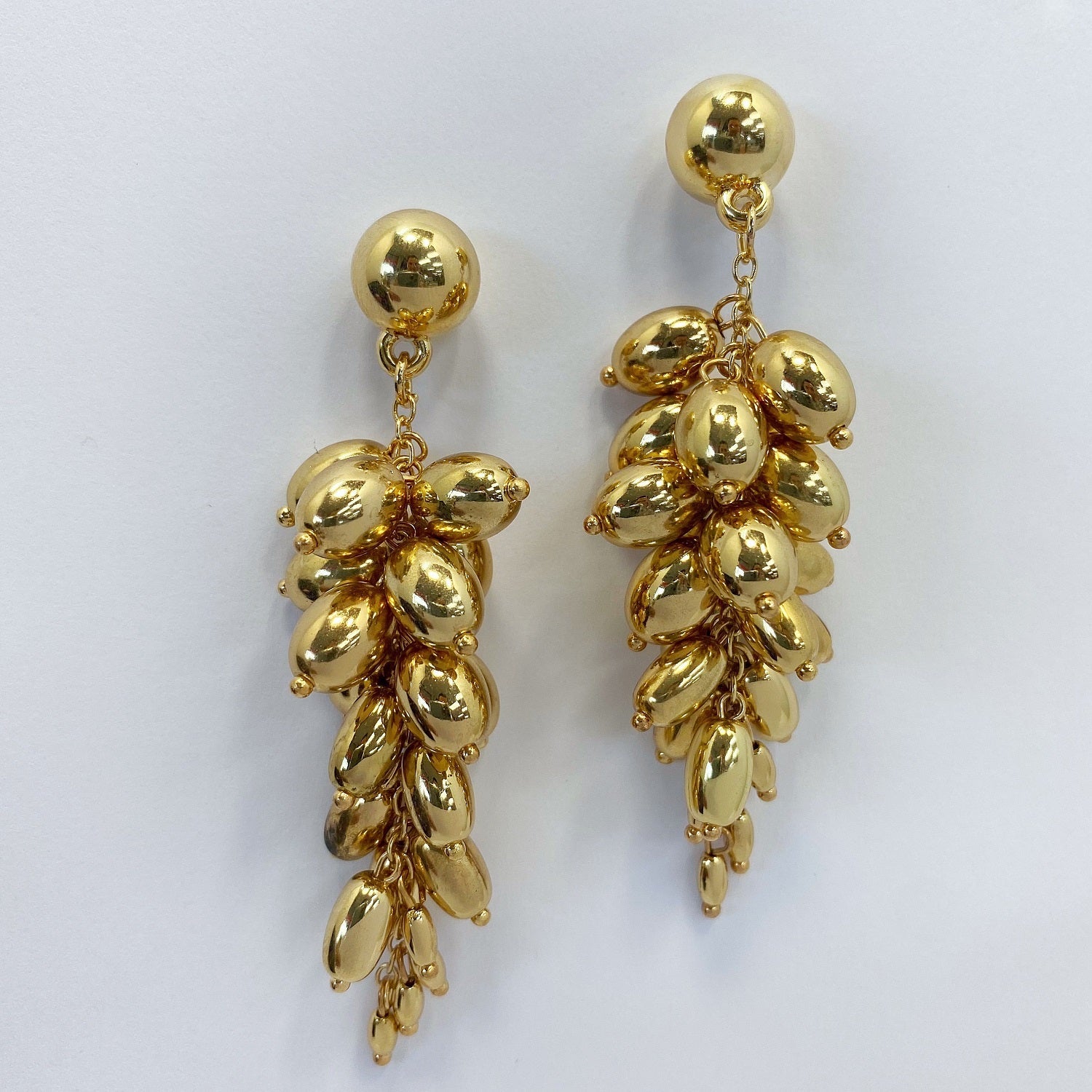 A gold earrings on a white background