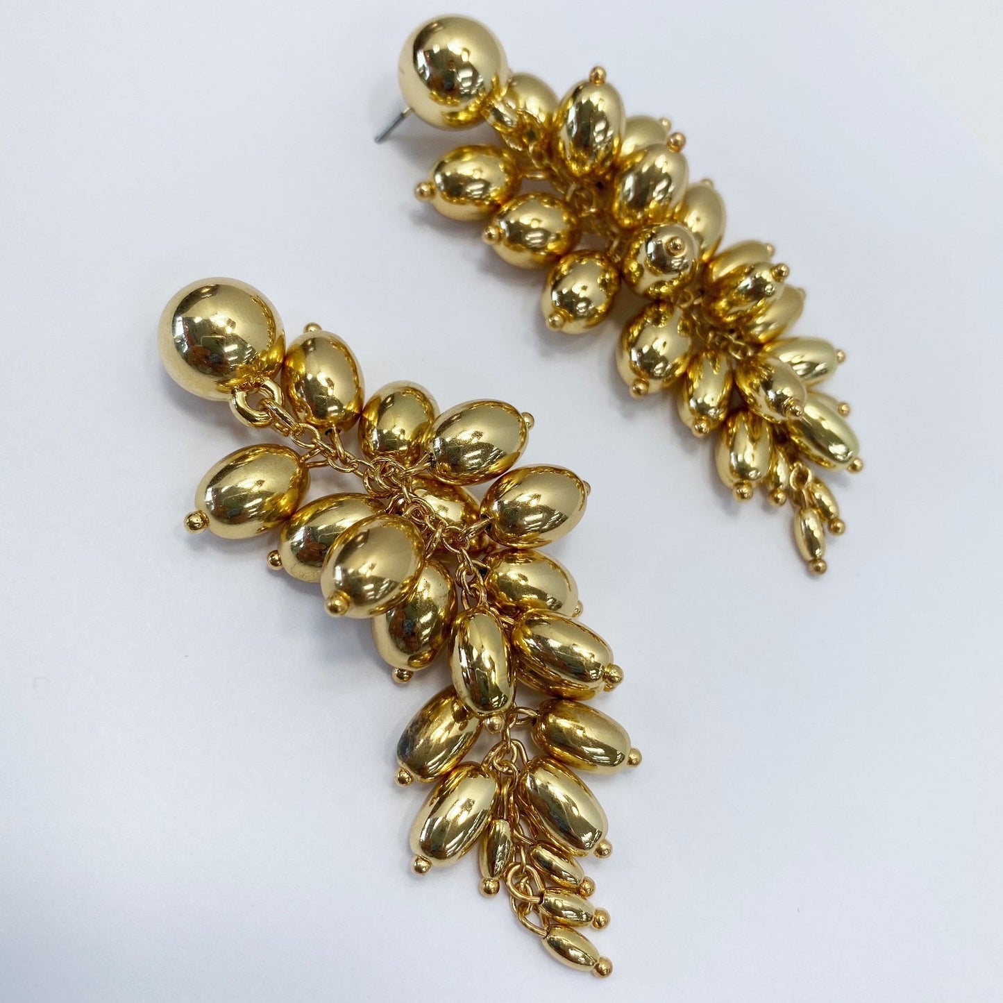 A gold earrings on a white background