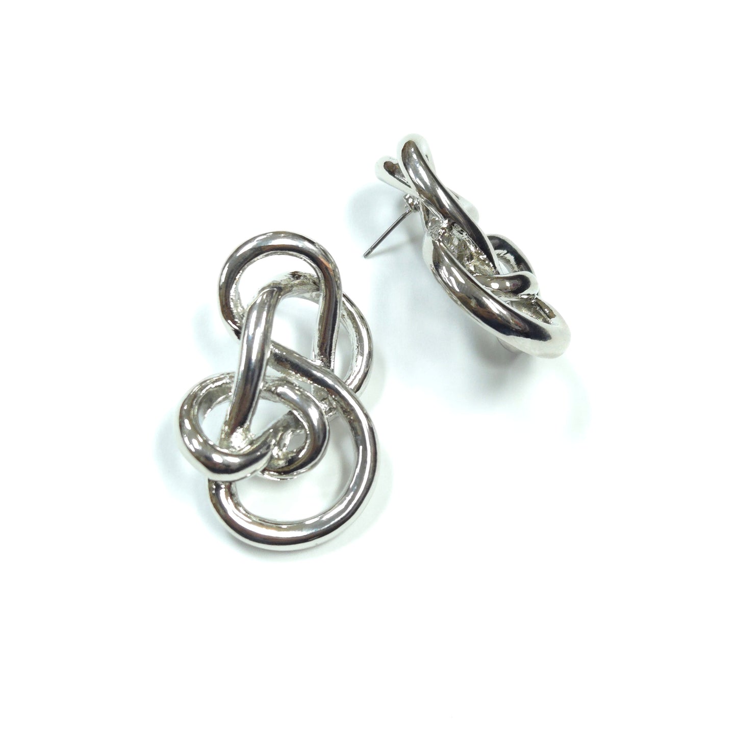 Silver knot-shaped earrings on a white background