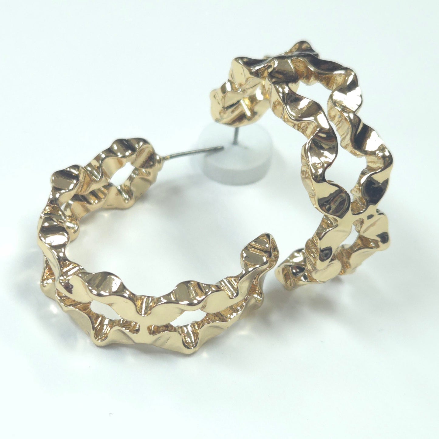 Gold hoop earrings on a white background