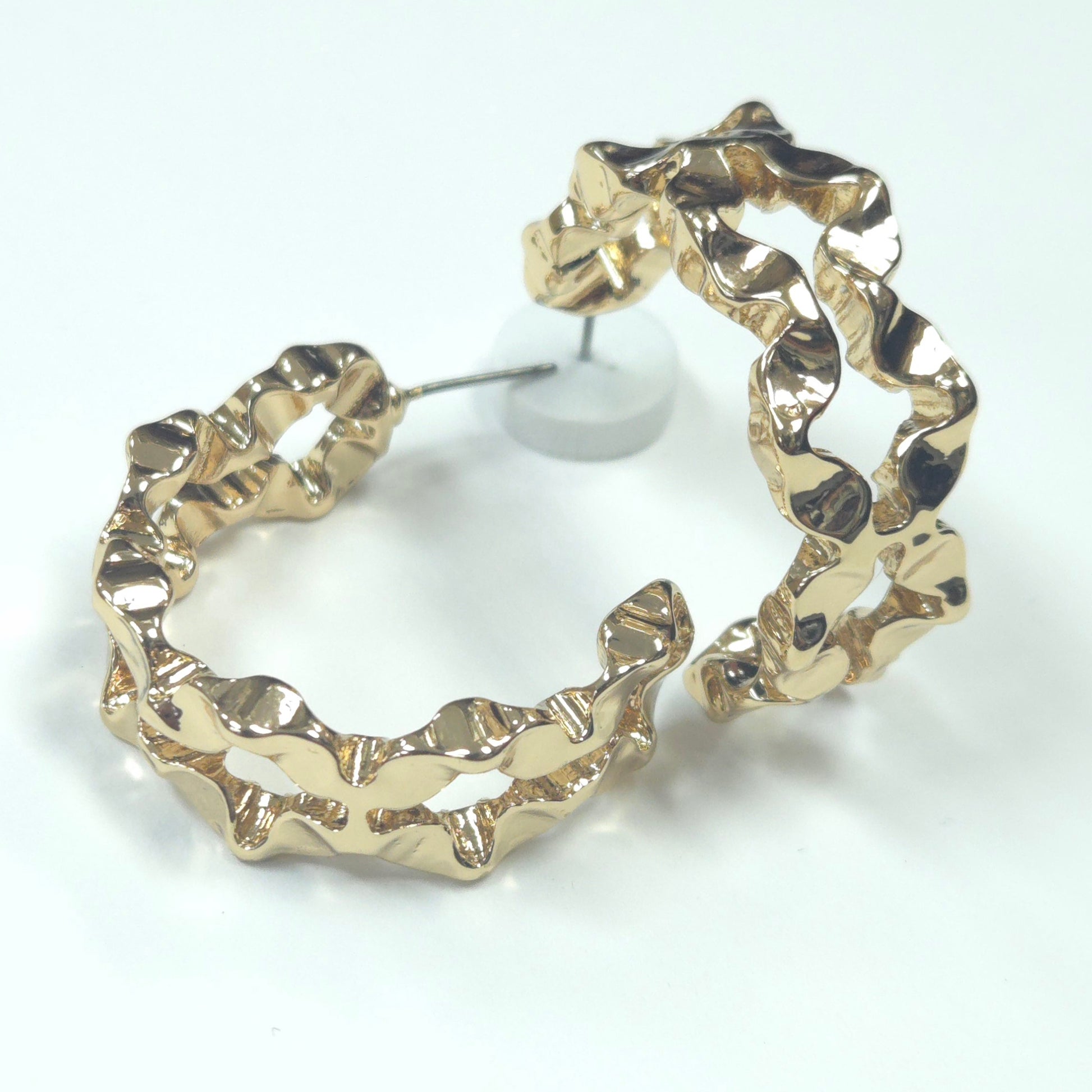 Gold hoop earrings on a white background