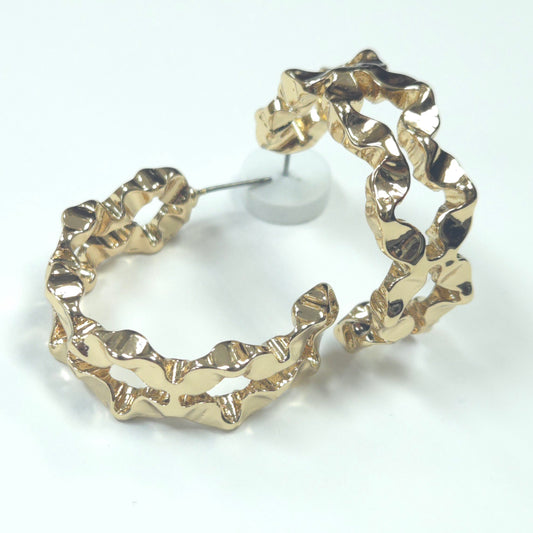 Gold hoop earrings on a white background