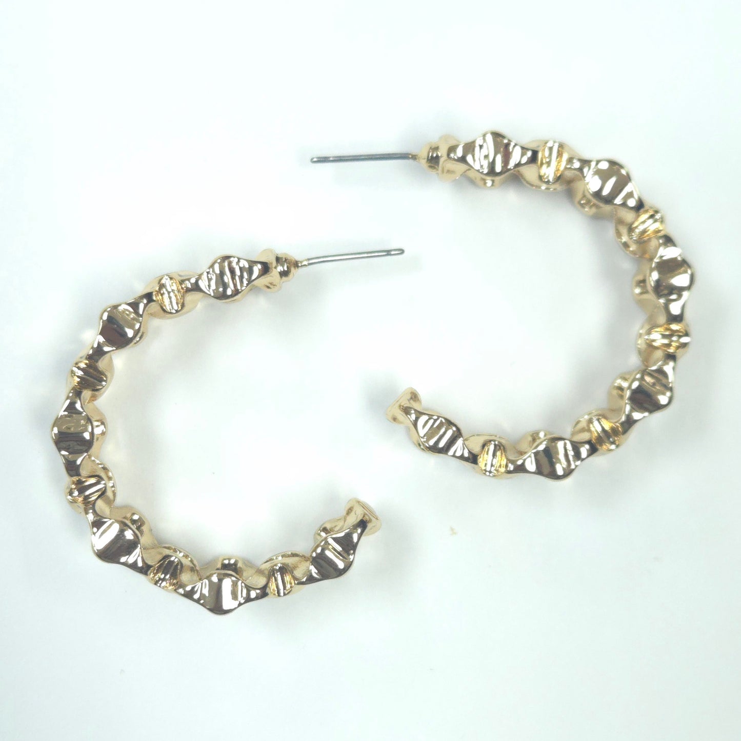 Gold hoop earrings on a white background