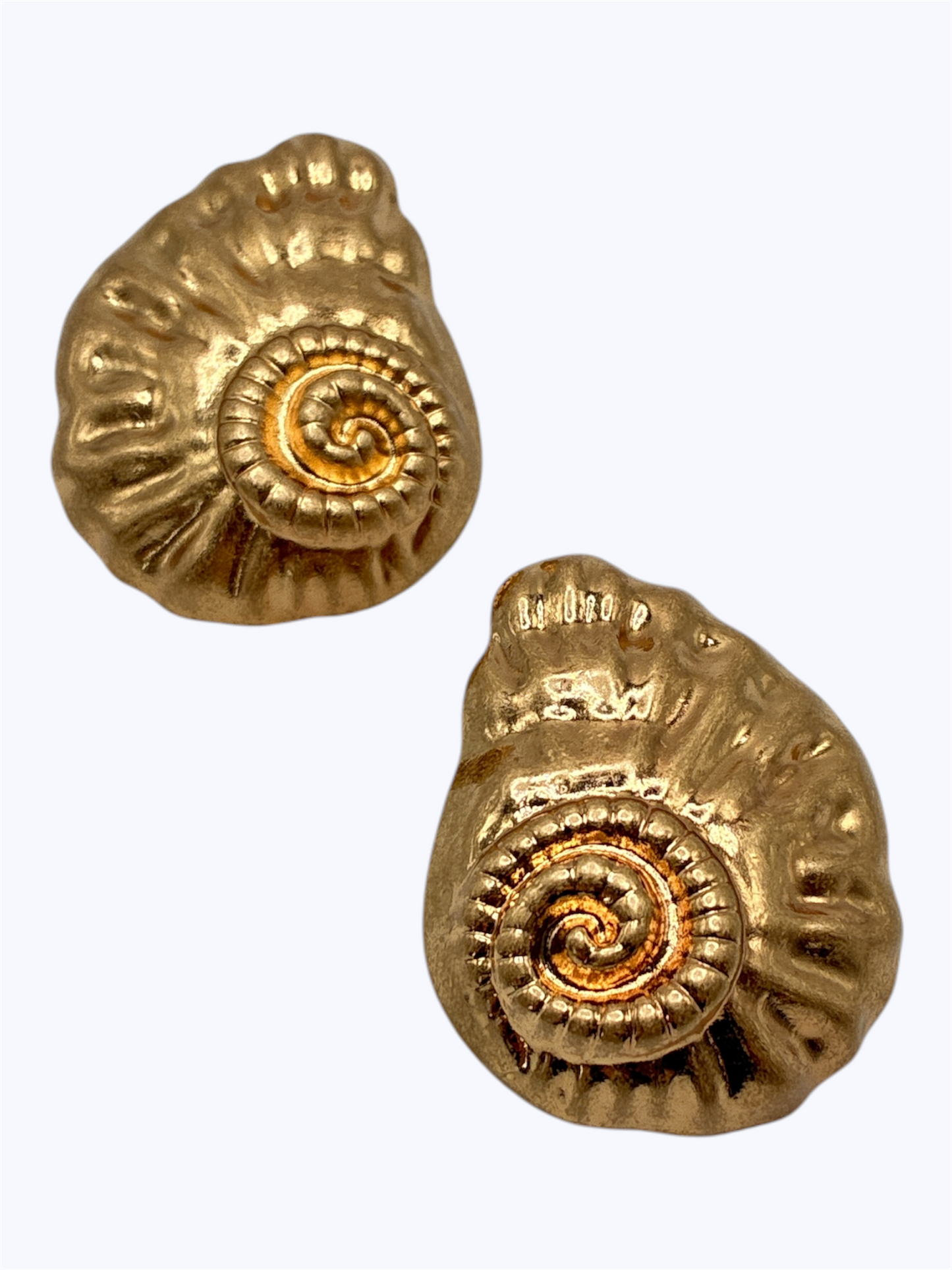 Textured spiral shell stud earrings with embossed metal detailing and vintage-inspired boutique style.