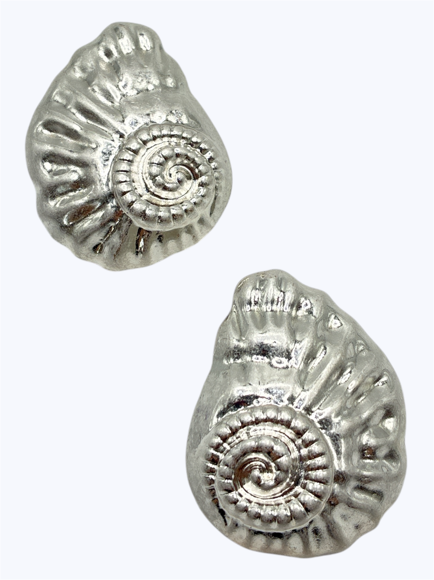 Textured spiral shell stud earrings with embossed metal detailing and vintage-inspired boutique style.
