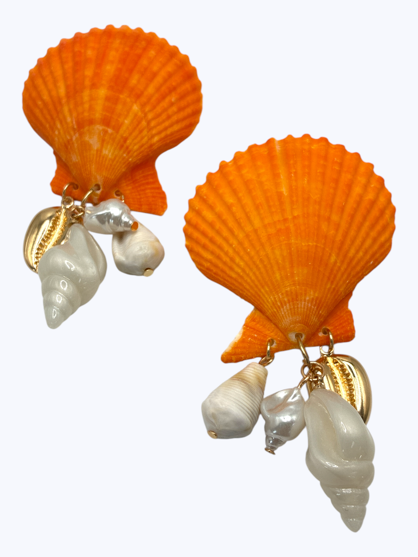 Large scallop shell earrings with dangling shell charms and gold tone accents in a coastal inspired statement design.