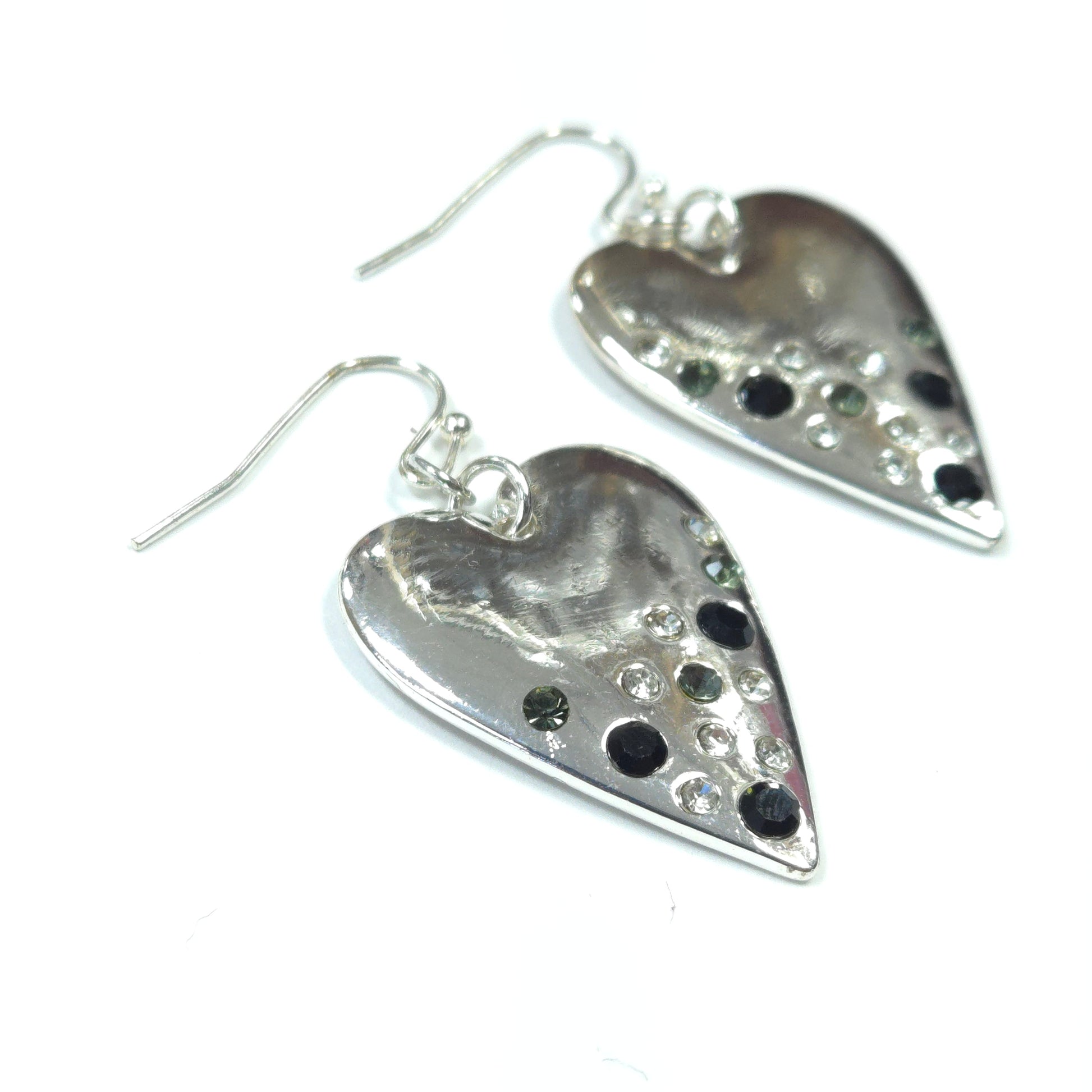Silver earrings with black and clear gemstones on a white background
