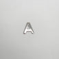 Silver letter 'A' charm on a light gray background
