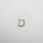 Silver letter 'D' charm on a light gray background