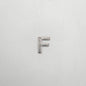 Silver letter 'F' charm on a white background