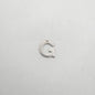 Silver letter 'G' charm on a light gray background