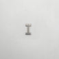 Metallic letter 'I' charm on a white background
