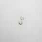 Silver letter 'J' charm on a light gray background