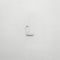 Silver letter 'L' charm on a white background