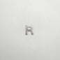 Silver letter 'R' charm on a white background