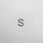 Silver letter 'S' charm on a white background