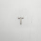 Silver letter 'T' charm on a white background