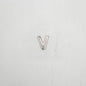 Silver letter 'V' charm on a light gray background