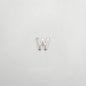 Silver letter 'W' charm on a light gray background