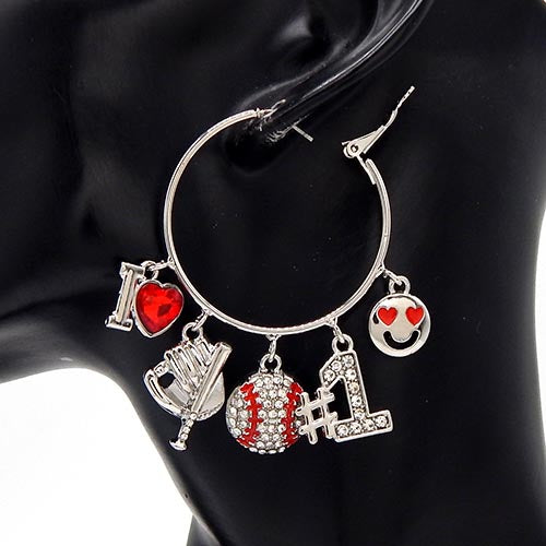 Silver hoop earrings with various charms on a black stand.