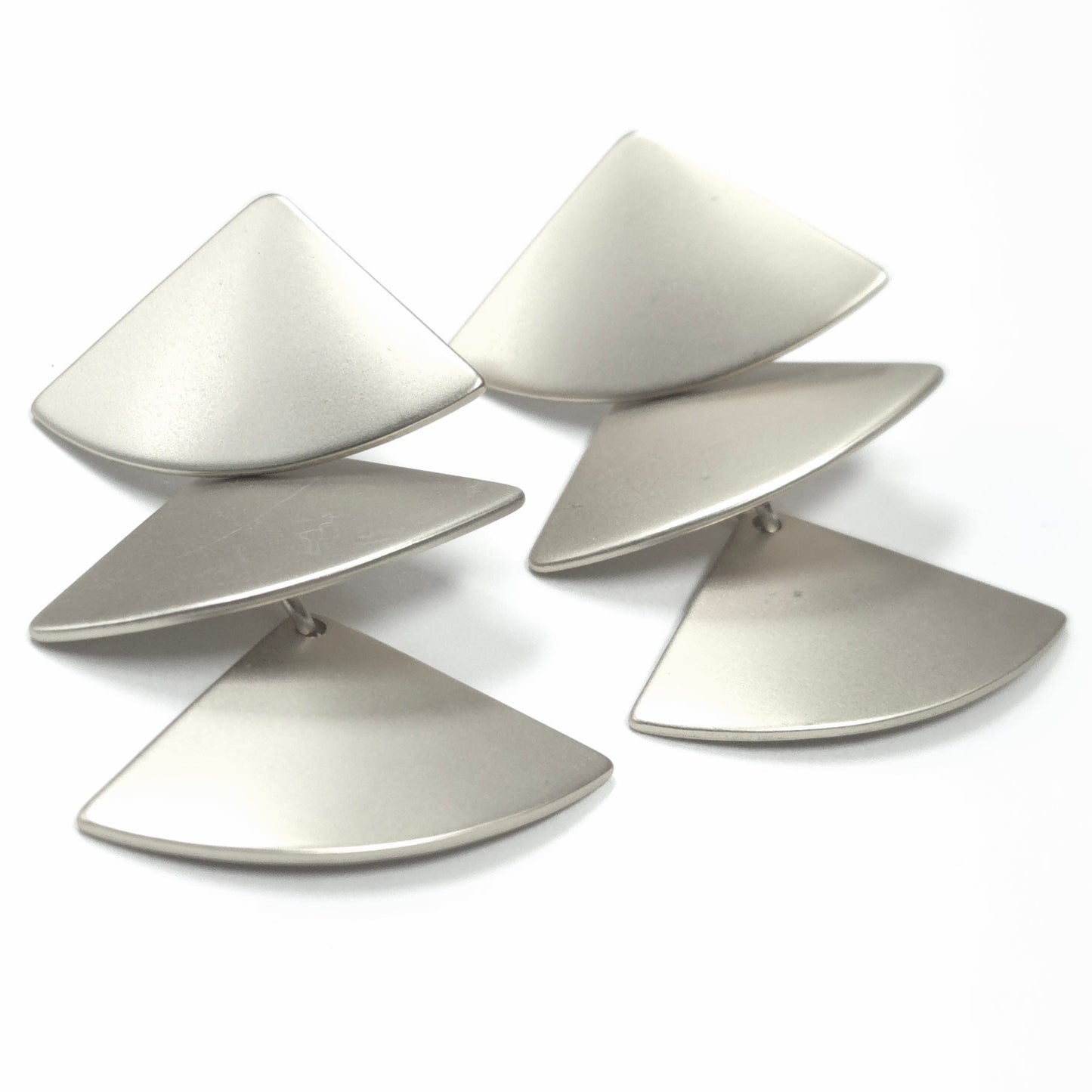 Set of five metallic leaf-shaped objects on a white background