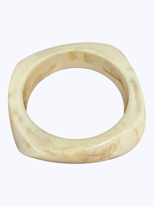 Minimalist marbled resin bangle bracelet with rounded square shape and polished glossy finish.