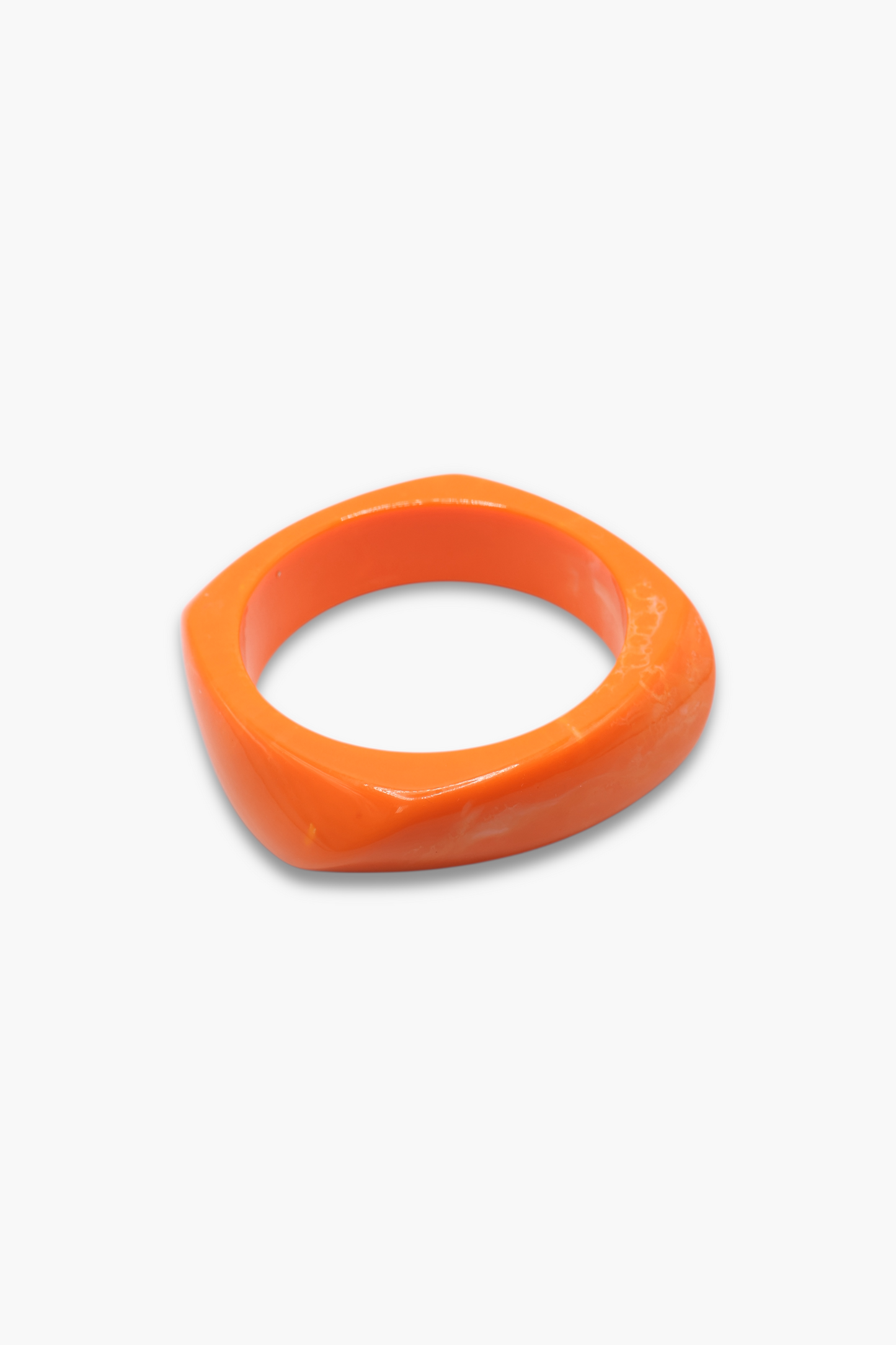 Minimalist marbled resin bangle bracelet with rounded square shape and polished glossy finish.