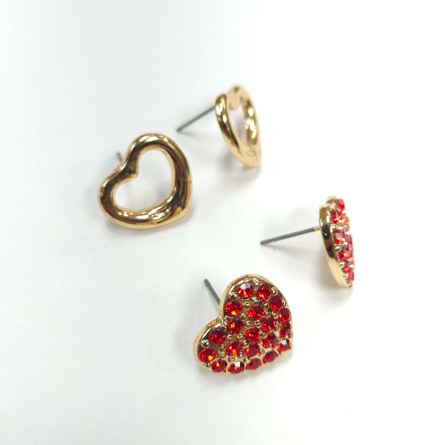 Heart-shaped earrings with gold and red details on a white background