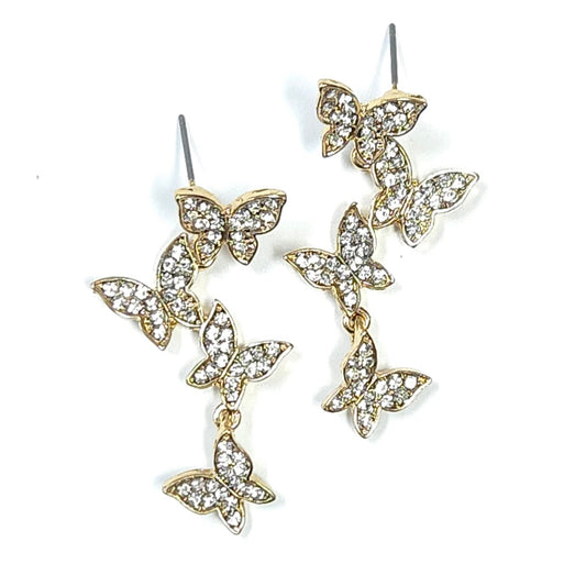 Butterfly-shaped earrings with gold and crystal details on a white background