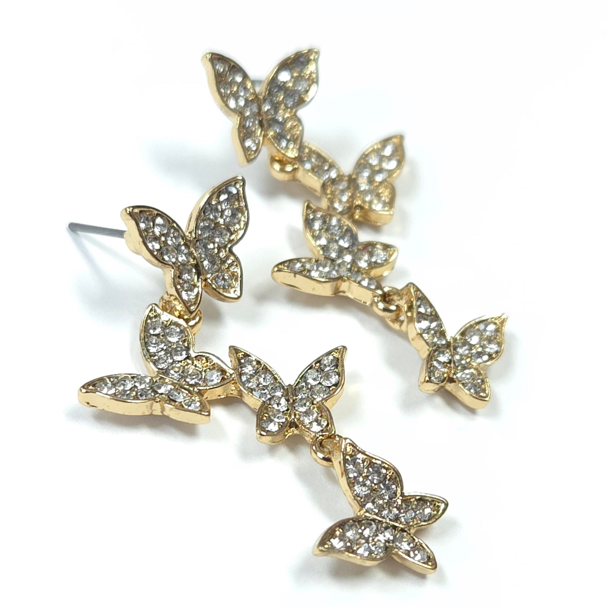 Gold butterfly earrings with clear gemstones on a white background