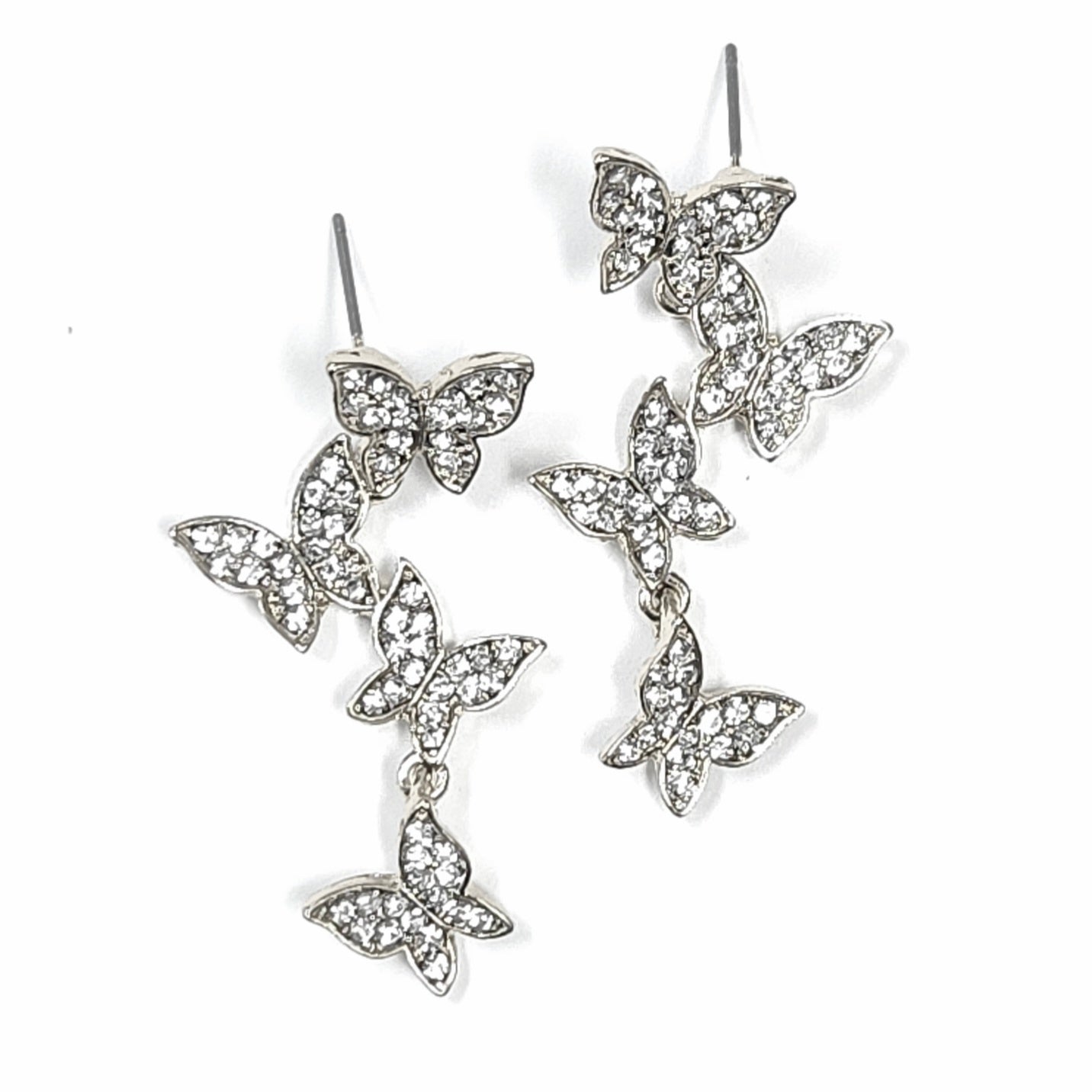 Butterfly-shaped earrings with clear gemstones on a white background