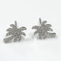 Silver palm tree earrings on a white background