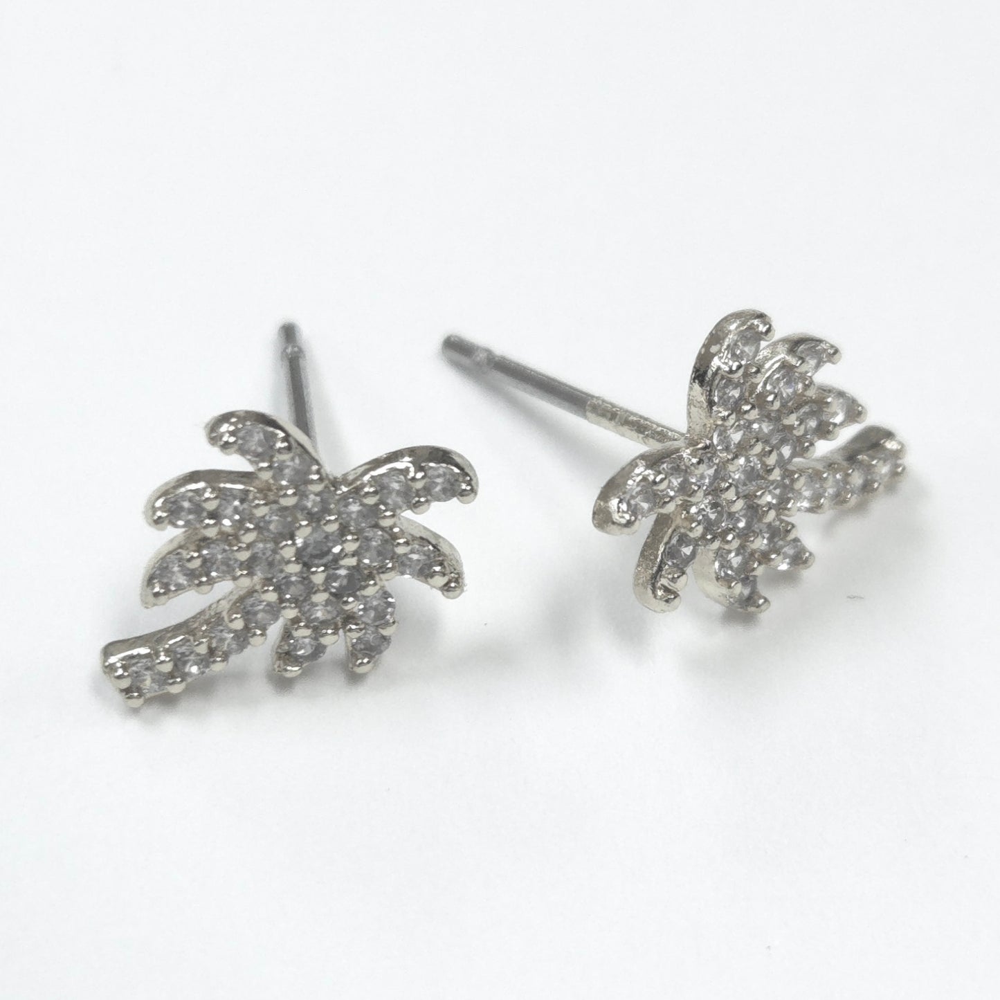 Silver palm tree earrings on a white background