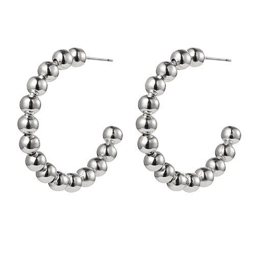 Silver beaded hoop earrings on a white background