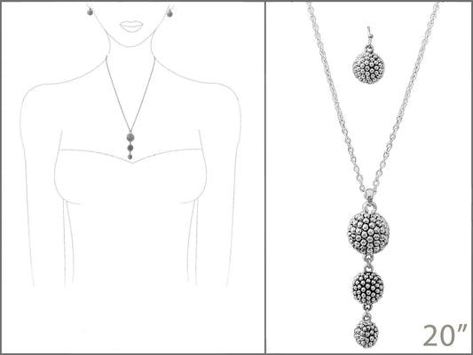 Silver necklace with spherical pendants on a white background