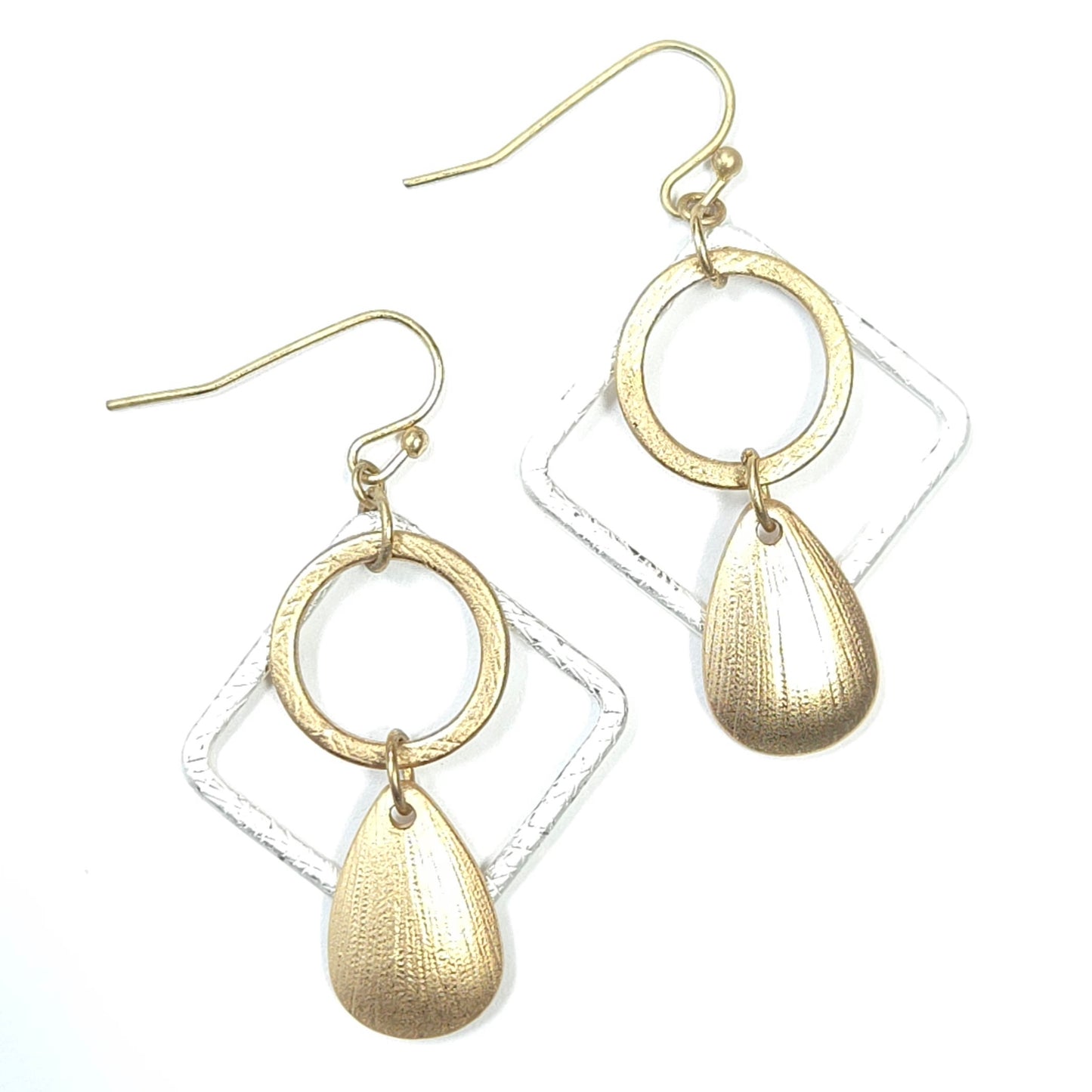 Gold hoop and teardrop earrings on a white background
