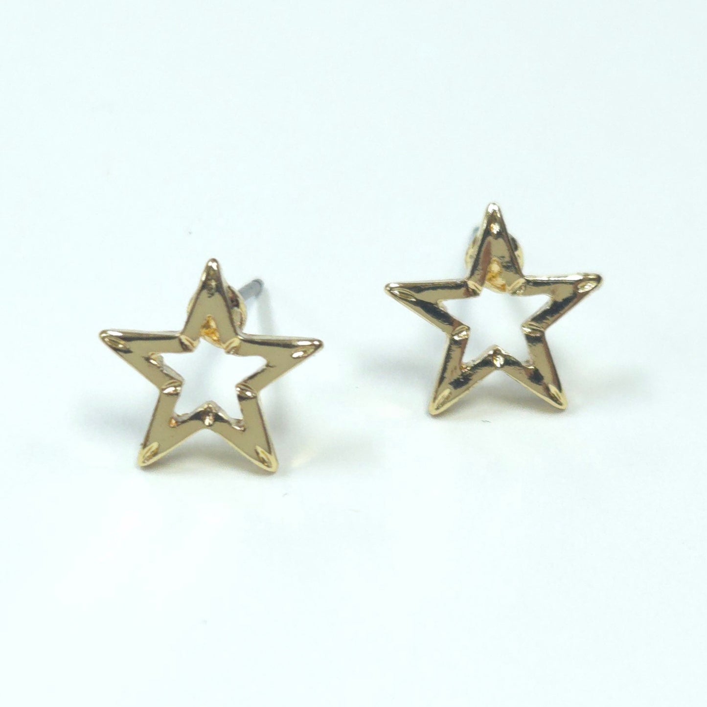 Gold star-shaped earrings on a white background