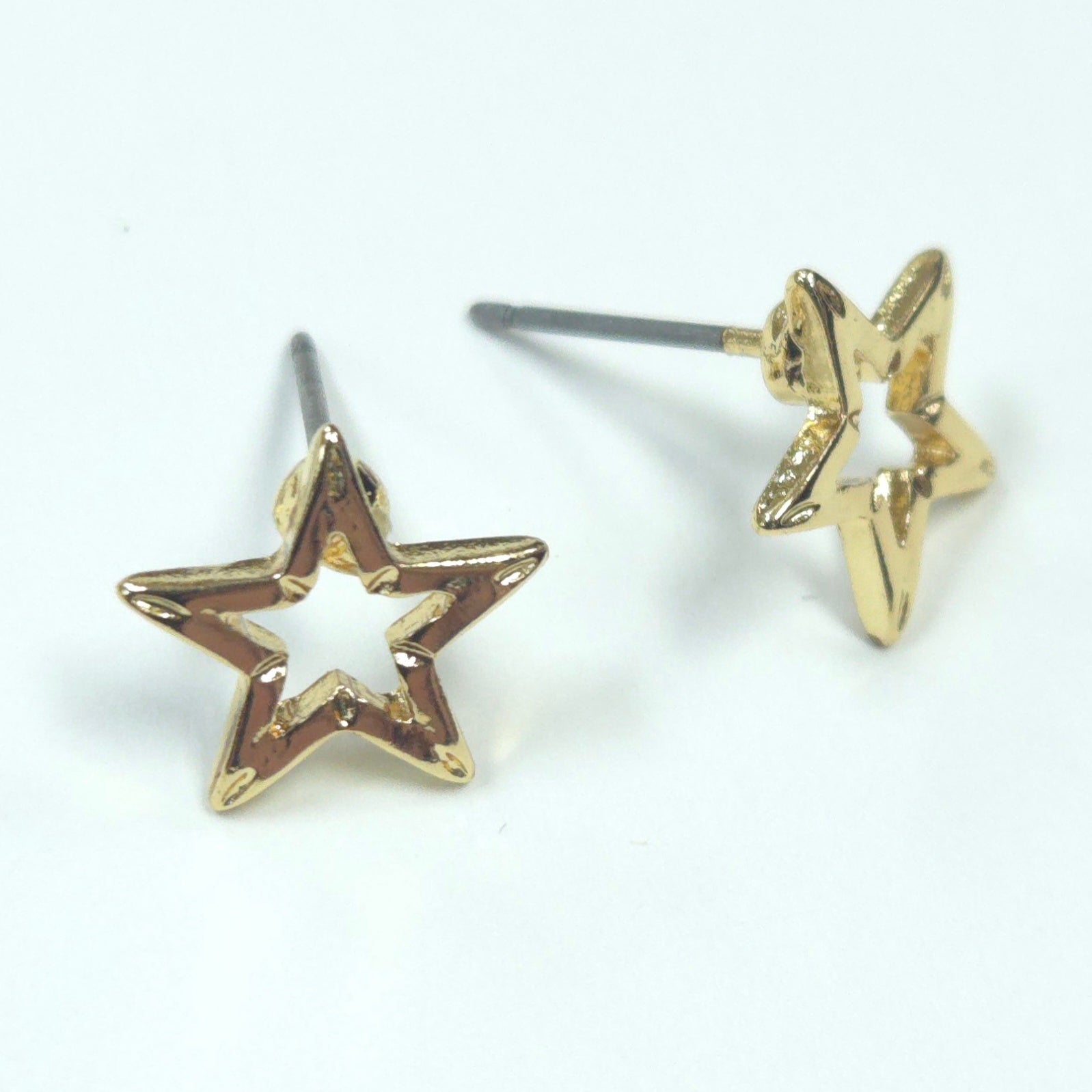 Gold star-shaped earrings on a white background
