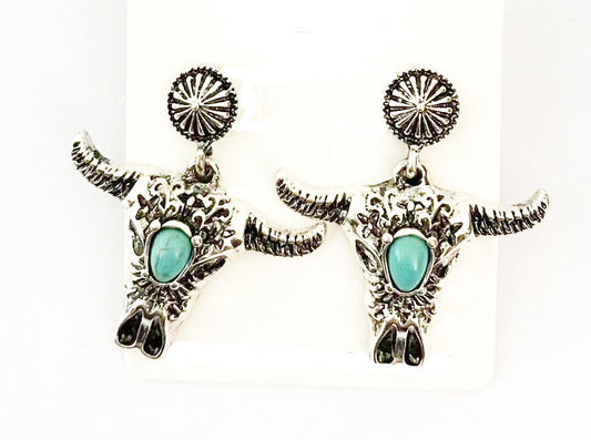 Silver bull head earrings with turquoise stones on a white background