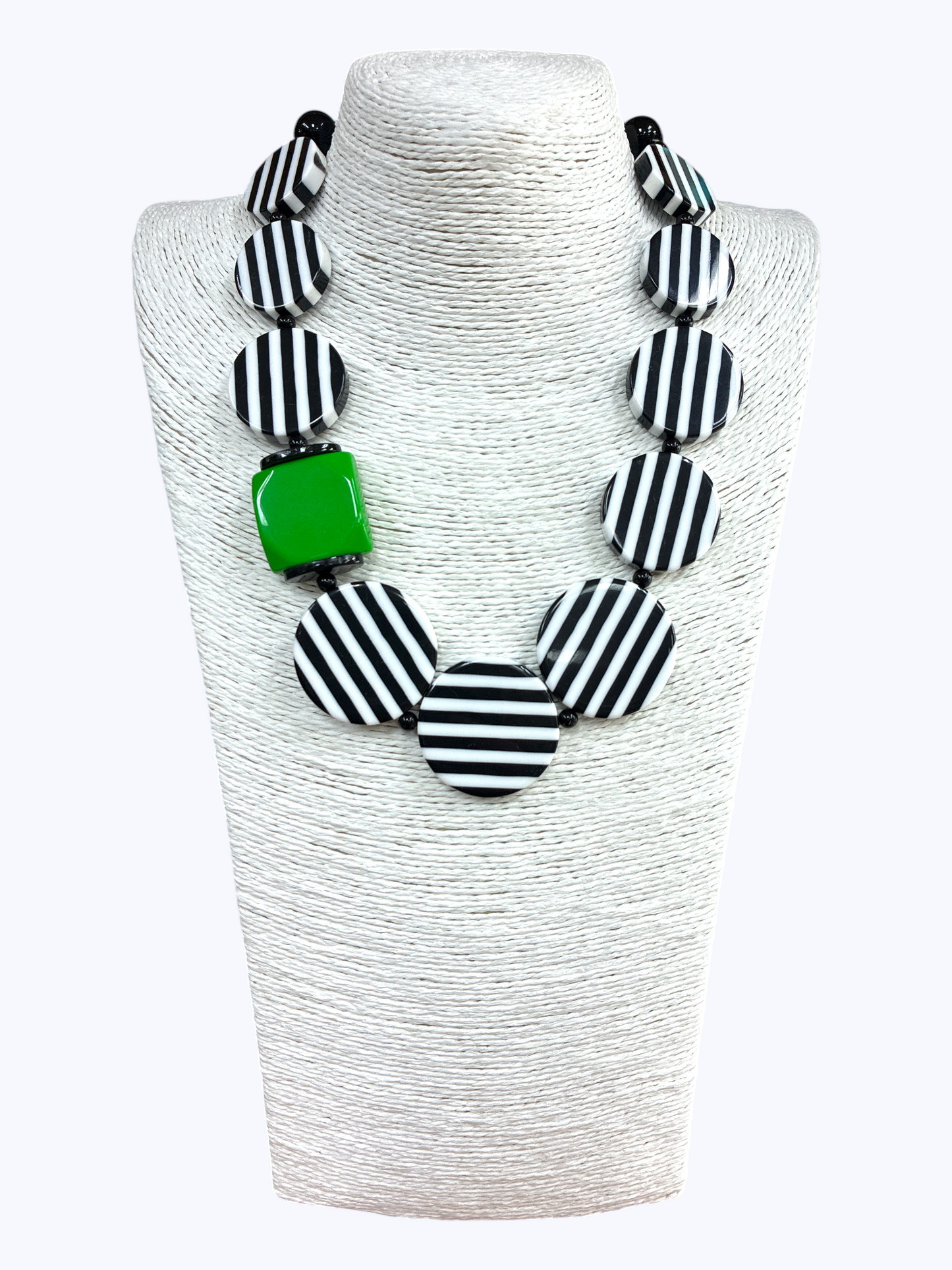 Chunky geometric statement necklace featuring striped resin disc beads with bold modern graphic detailing and oversized accents.