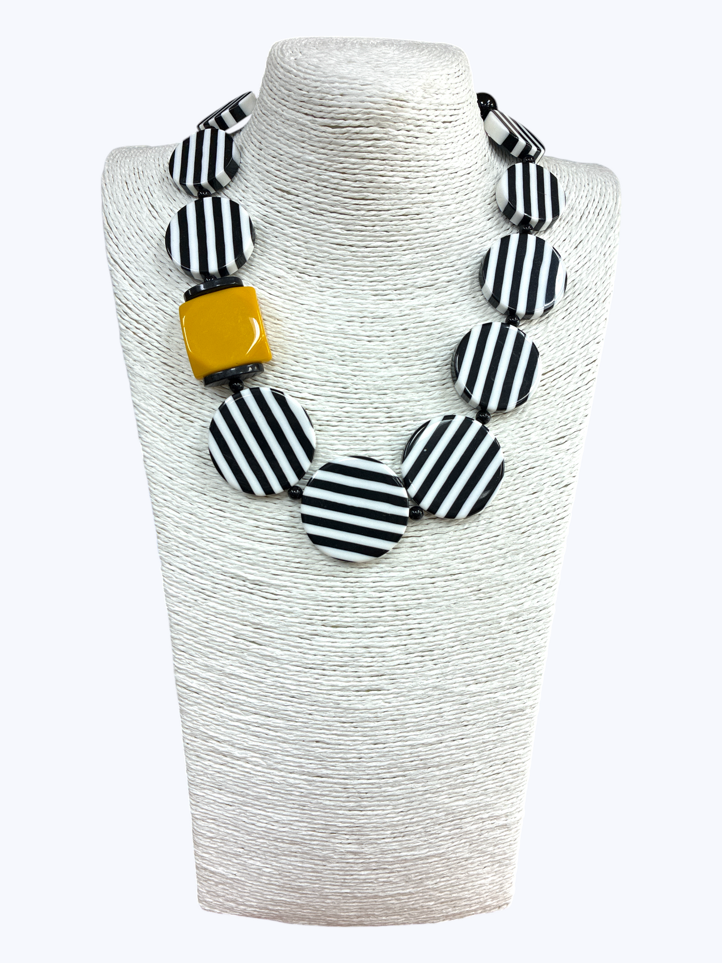 Chunky geometric statement necklace featuring striped resin disc beads with bold modern graphic detailing and oversized accents.