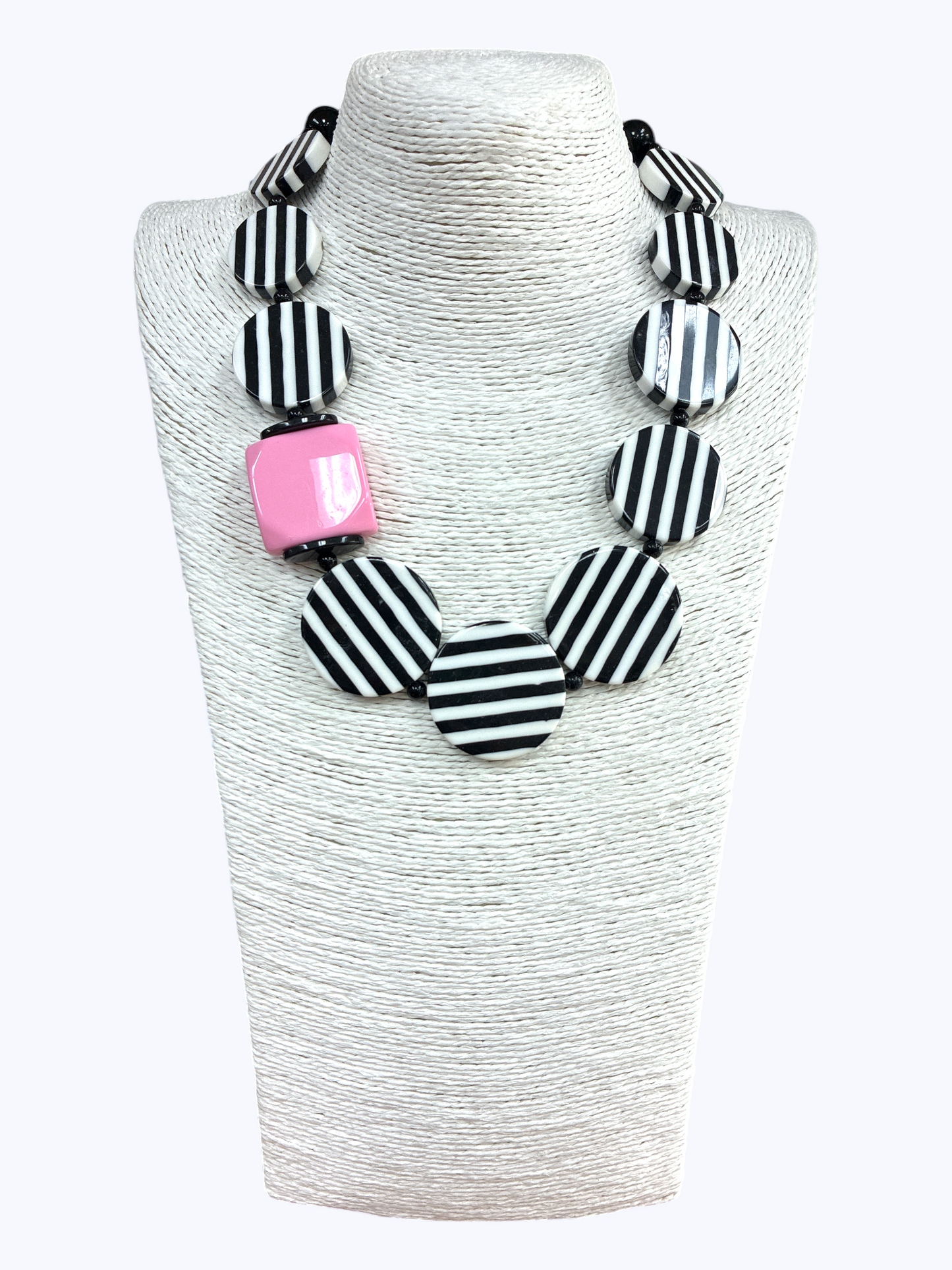 Chunky geometric statement necklace featuring striped resin disc beads with bold modern graphic detailing and oversized accents.