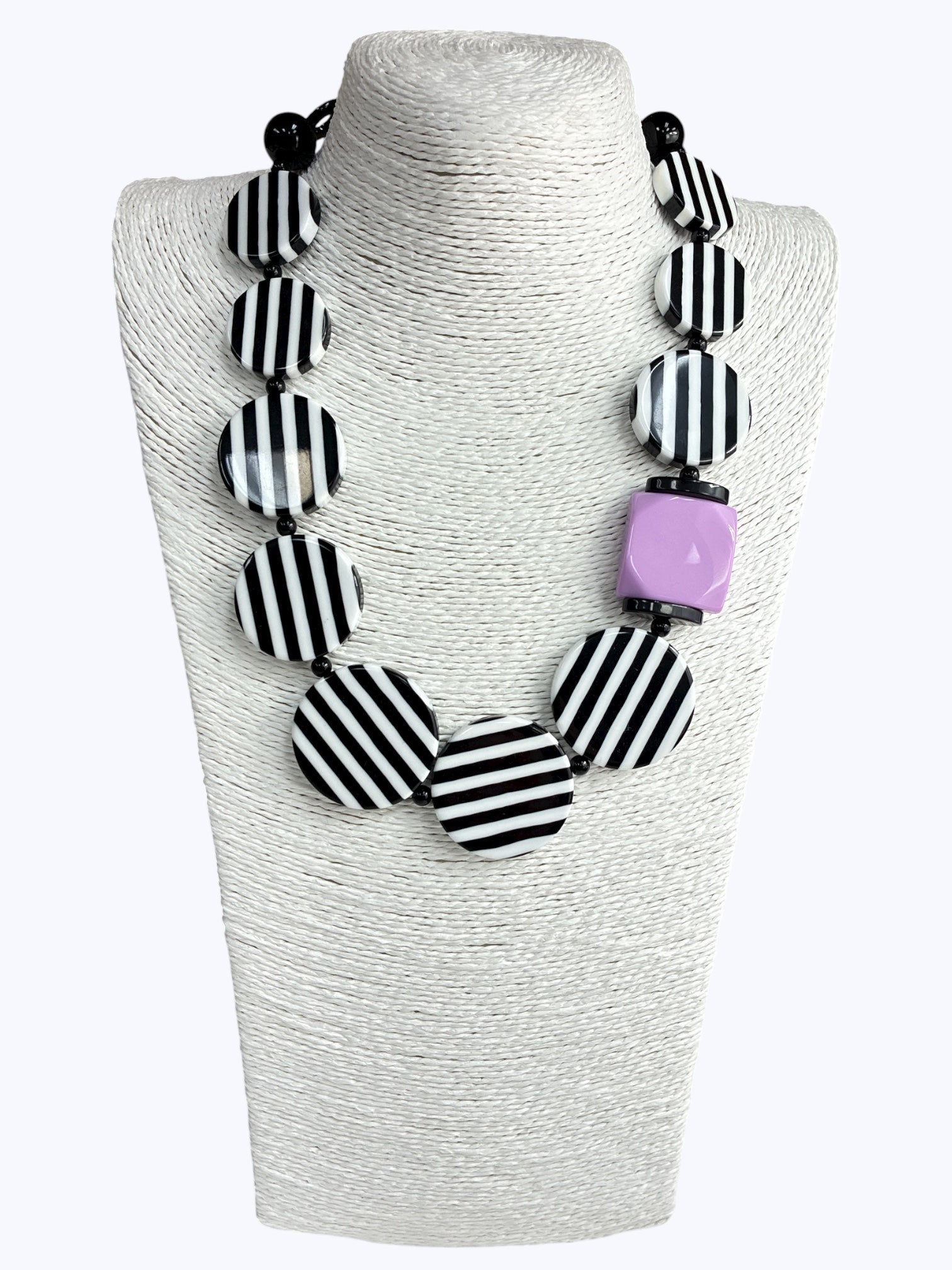 Chunky geometric statement necklace featuring striped resin disc beads with bold modern graphic detailing and oversized accents.
