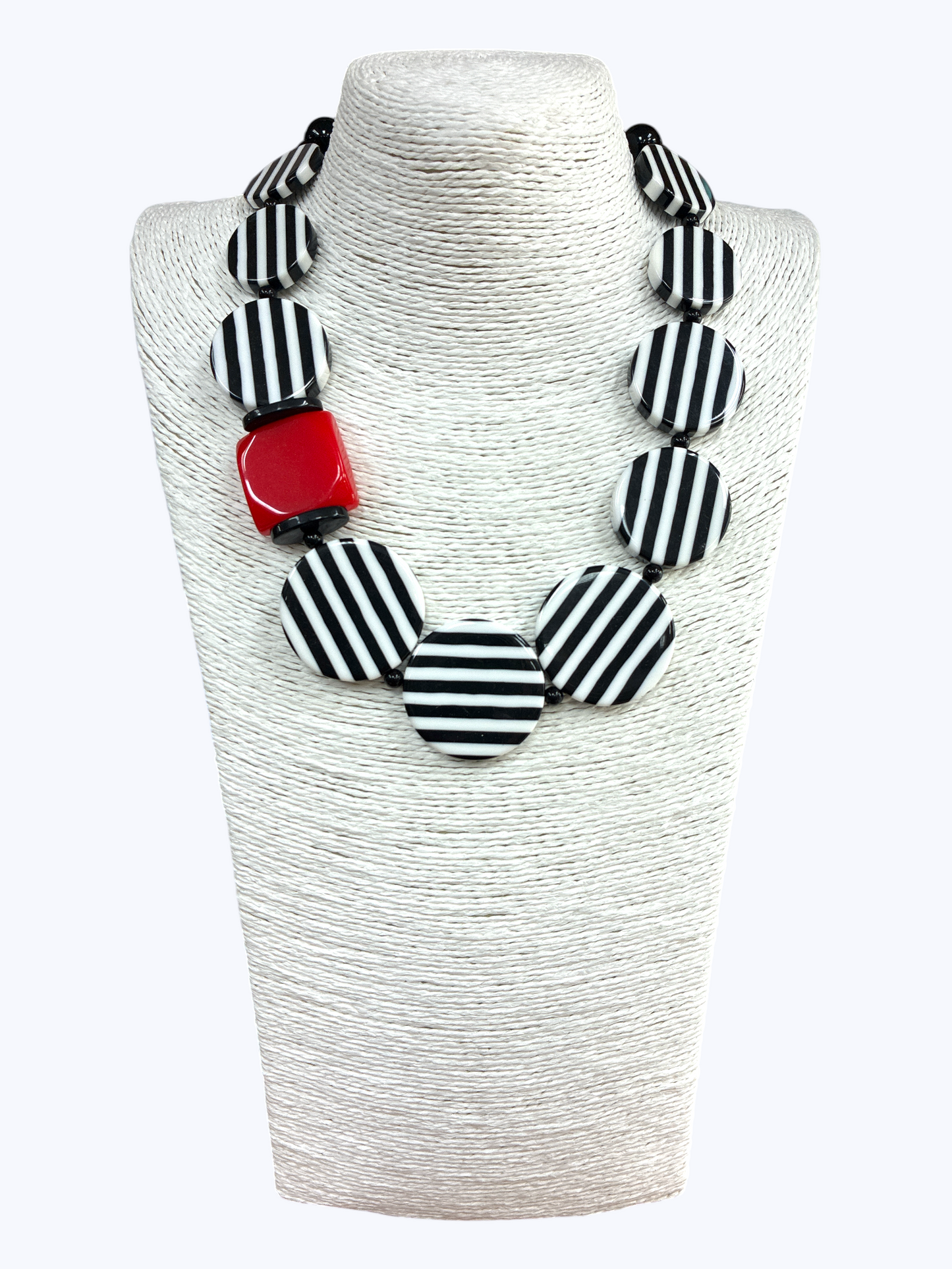 Chunky geometric statement necklace featuring striped resin disc beads with bold modern graphic detailing and oversized accents.