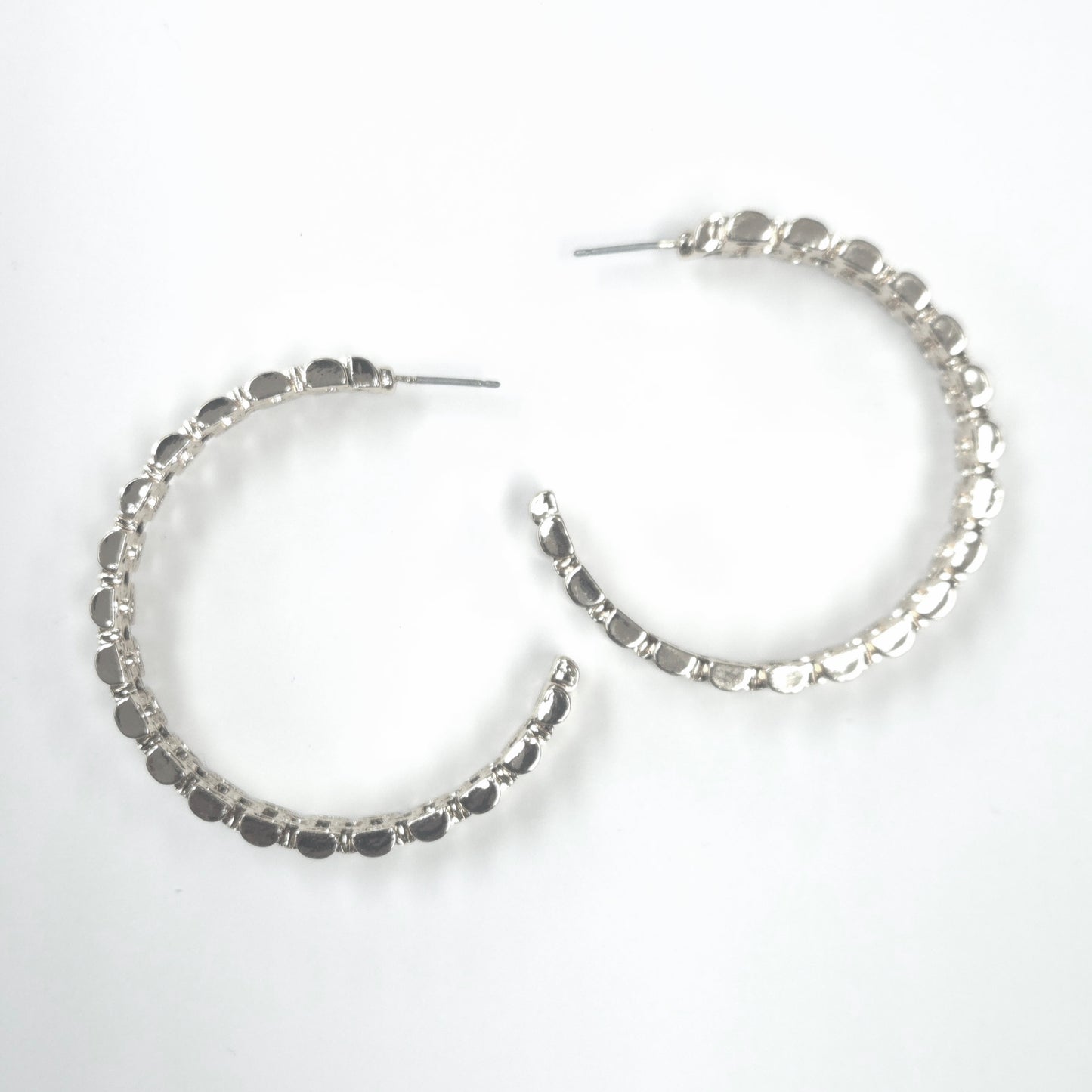 Silver hoop earrings on a white background