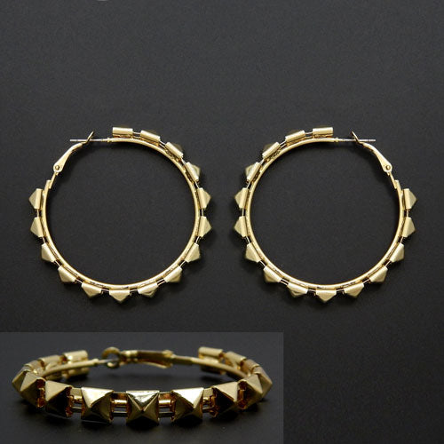 Geometric studded hoop earrings with pyramid accents and structured modern design on dark background