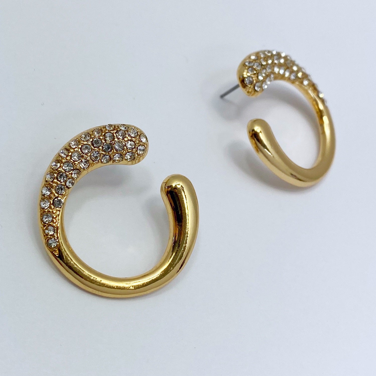 a Gold earrings on a white background