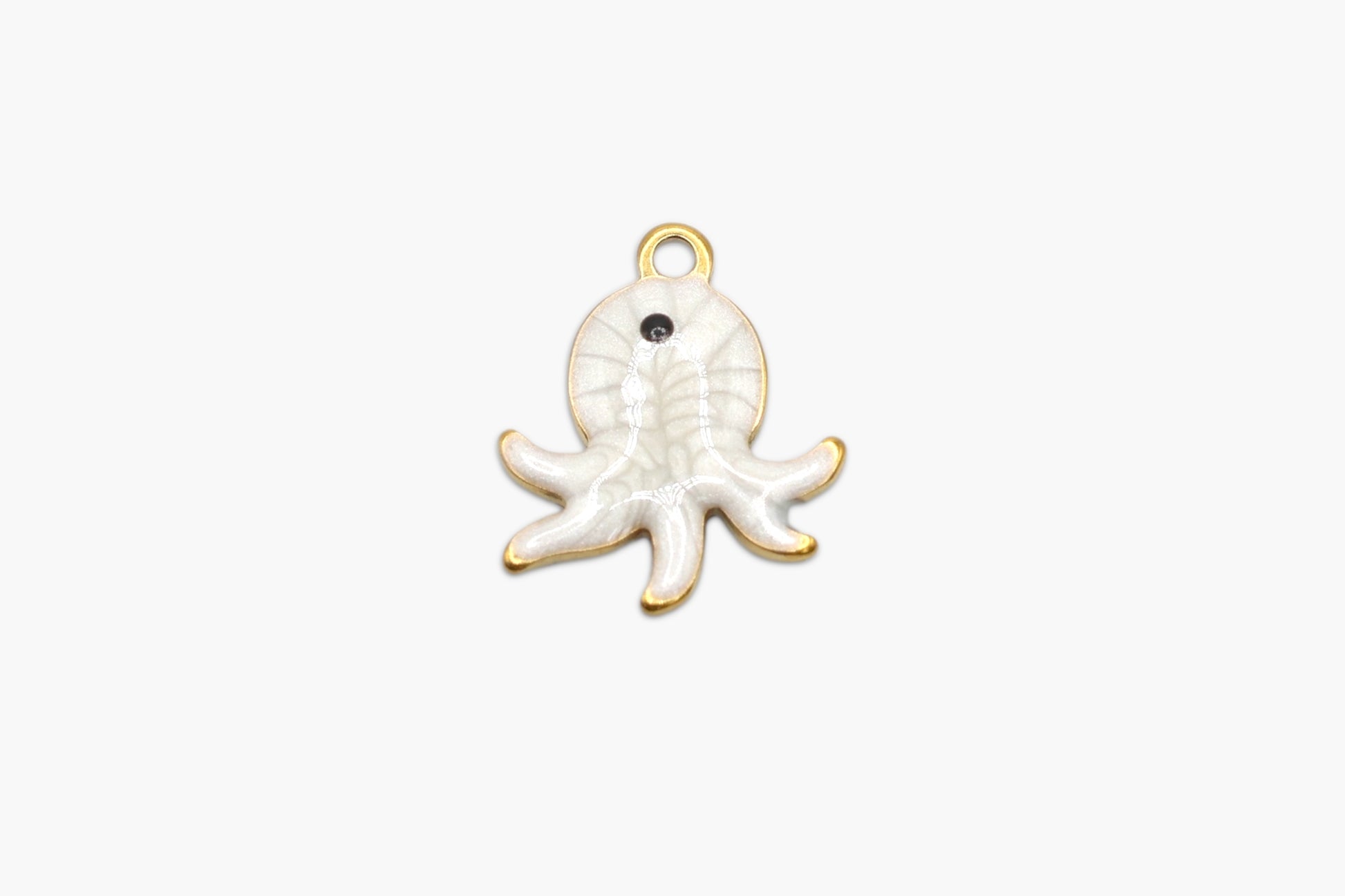 Gold and white octopus charm on a white background