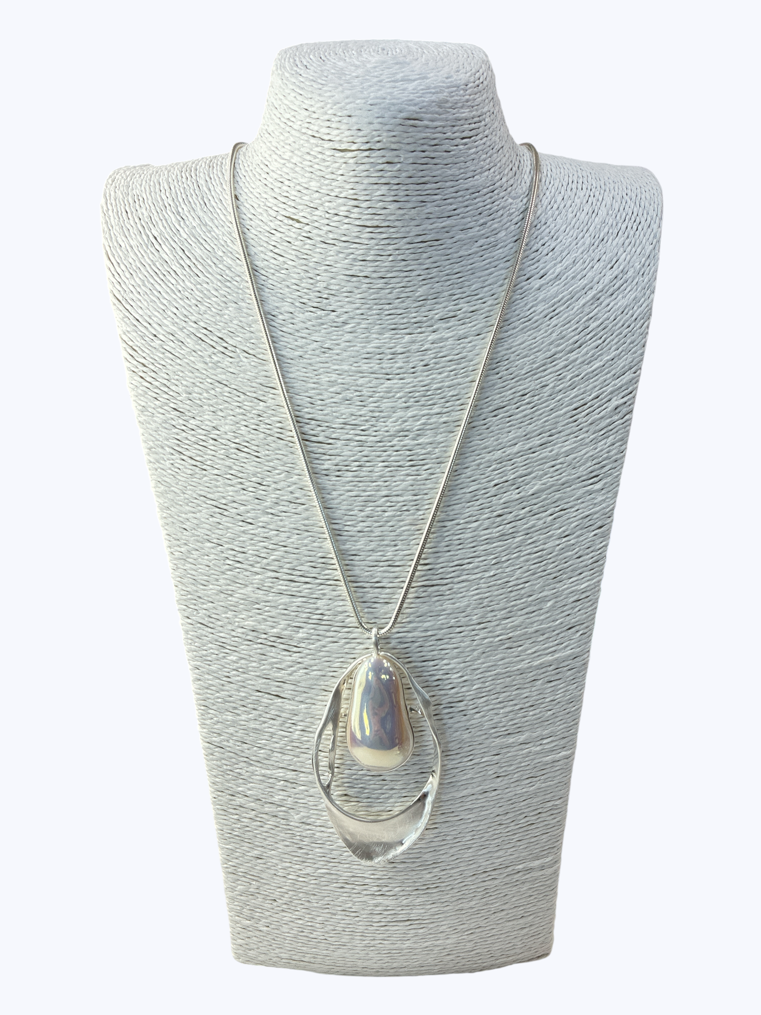 Necklace with a large teardrop-shaped pendant on a gray mannequin bust against a white background